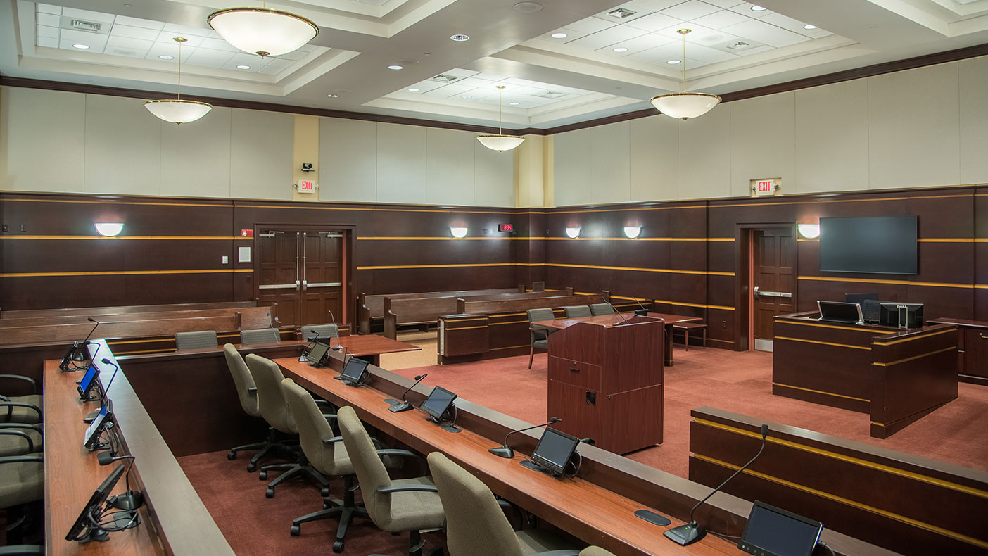 The courtroom now has a more traditional civic image compared to the previous office building where court functions were conducted.