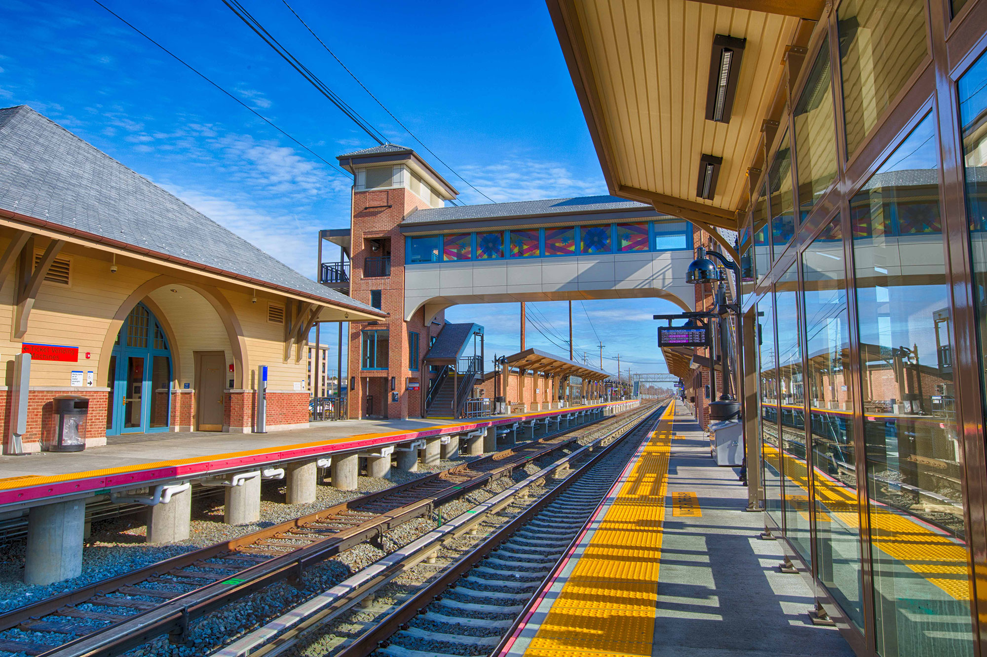 Wyandanch Station pedestrian bridge with elevator towers, track platforms, and pedestrian shelters. Photo courtesy of Dewberry.