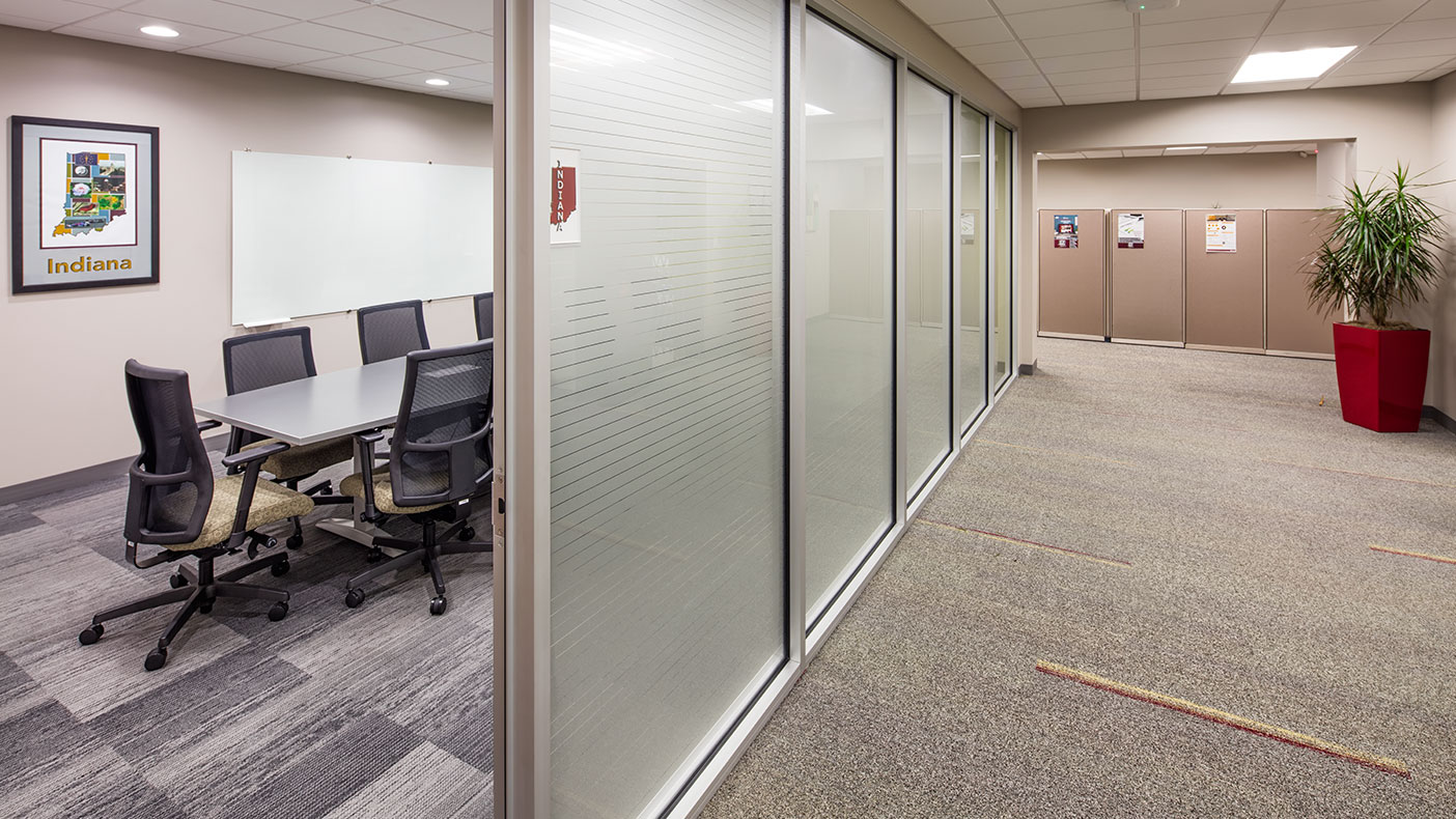Frosted glass paneled offices and workstations allow perimeter daylighting into the workplace.